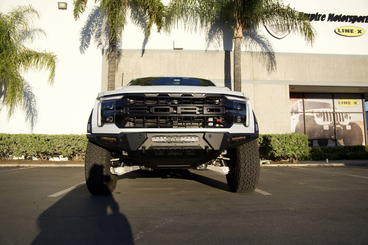 Front view of a Ford F-150 Raptor R with an ADD Offroad front bumper, built by Empire Motorsports & LINE-X in Rancho Cucamonga