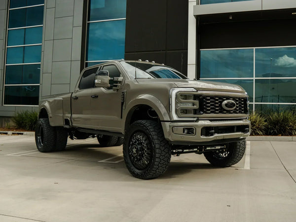 Front three-quarter view of a lifted 2026 Ford F-450 Platinum dually with a Carli Suspension lift and American Force wheels, built by Empire Motorsports & LINE-X in Rancho Cucamonga, CA