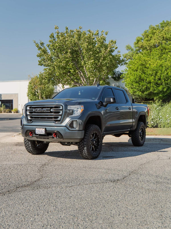Front three-quarter view of a gray GMC Sierra 1500 AT4 with a BDS lift and Fuel wheels, built by Empire Motorsports & LINE-X in Rancho Cucamonga