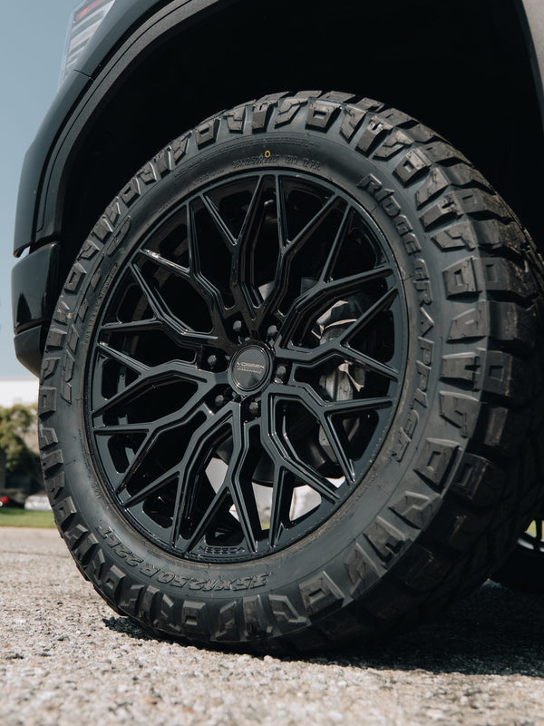 Close-up of a black Vossen wheel with a Nitto Ridge Grappler tire on a GMC Sierra 1500 Denali built by Empire Motorsports & LINE-X in Rancho Cucamonga