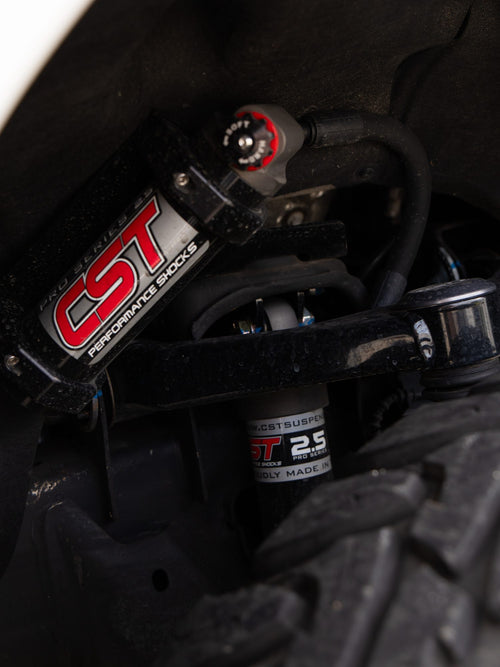 CST reservoir shock mounted above the tire on a GMC Sierra 2500 HD