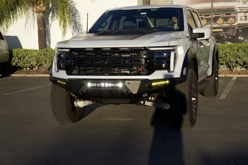 Front three-quarter view of a Ford F-150 Raptor R with Baja Designs auxiliary lights in the bumper