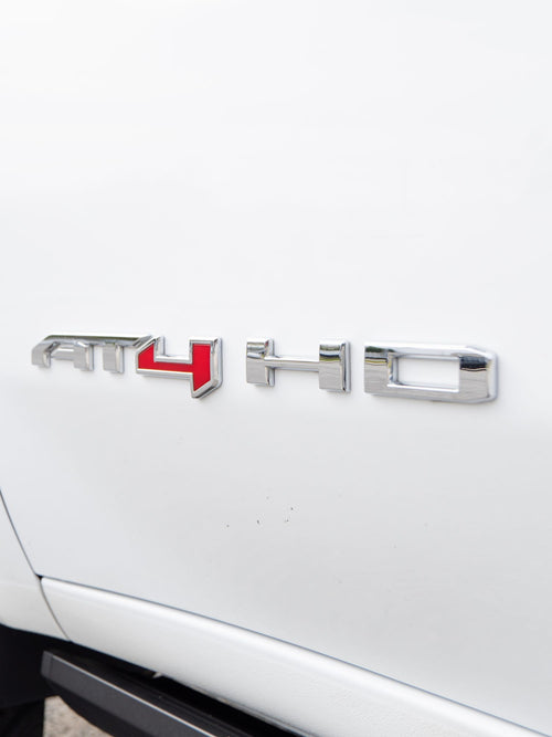 AT4 HD badge on the side of a white GMC Sierra 2500 HD