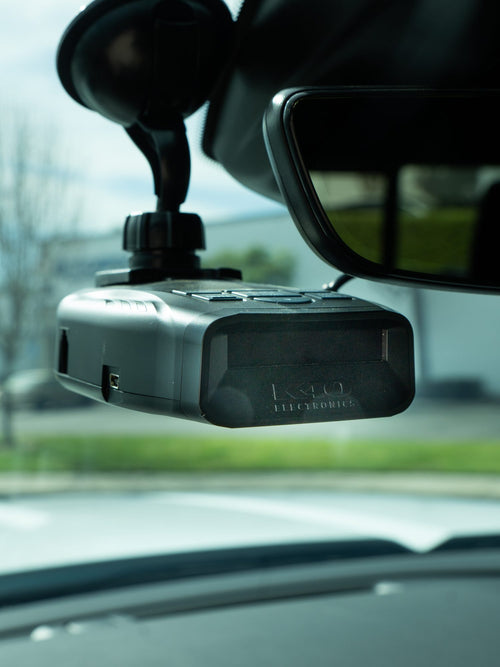 K40 driver alert system mounted on the windshield of a GMC Sierra 2500 HD