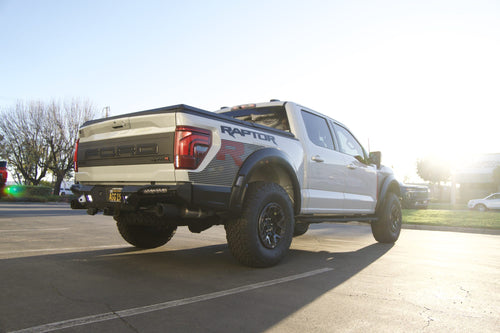 Rear three-quarter view of a Ford F-150 Raptor R showing the Baja Designs backup lights on the rear bumper