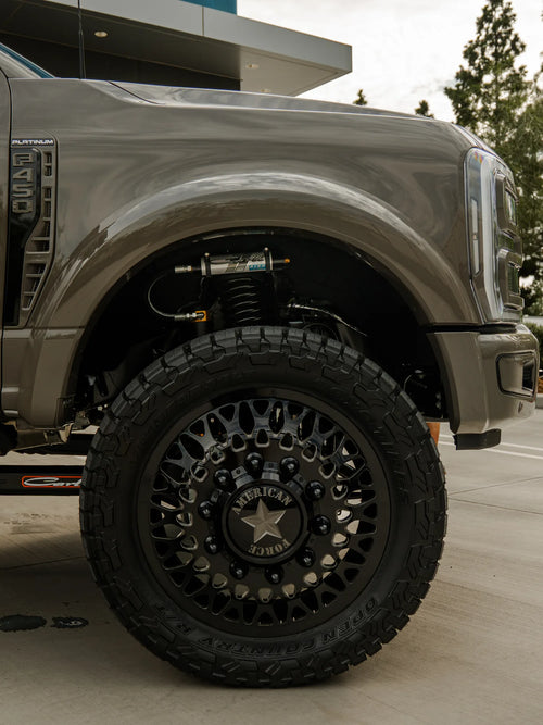 American Force wheels and Toyo Open Country R/T tires on the front fender of the Ford F-450