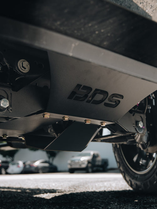 Side underside view of the BDS lift kit crossmember on a GMC Sierra