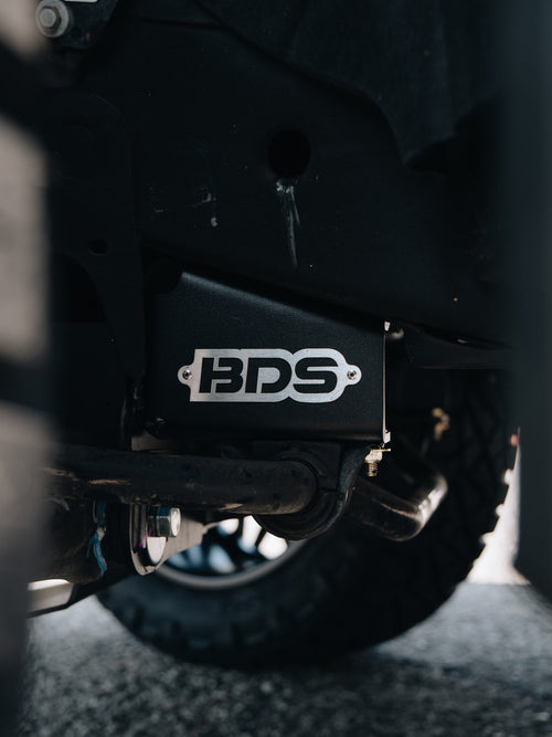 BDS-branded suspension component behind the front wheel of a lifted GMC Sierra