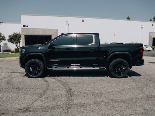 Side view of a lifted black GMC Sierra Denali on Vossen wheels