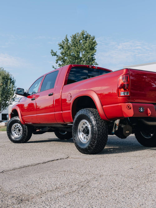 Rear three-quarter view of a red Dodge Ram HD with a TrailReady rear bumper