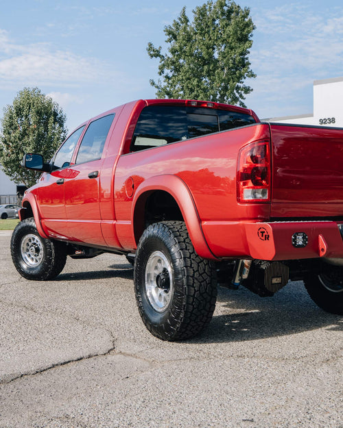 Rear three-quarter view of a red Dodge Ram HD with a TrailReady rear bumper