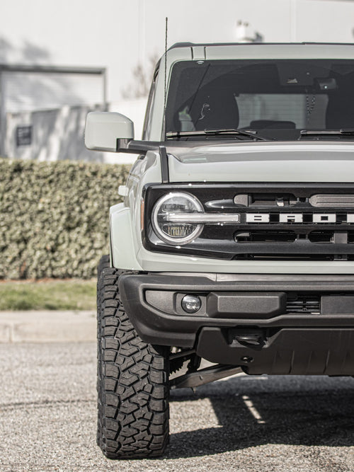 Close-up of the front end of a gray Ford Bronco with its BRONCO grille lettering