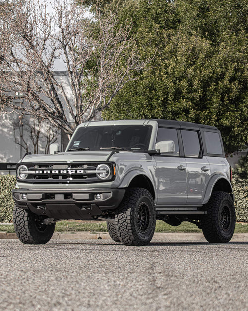 Front three-quarter view of a gray four-door Ford Bronco with black wheels