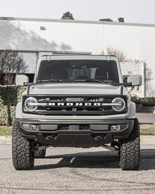 Head-on front view of a gray Ford Bronco with round headlights