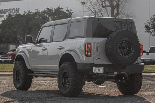 Rear three-quarter view of a gray Ford Bronco with a rear-mounted spare tire