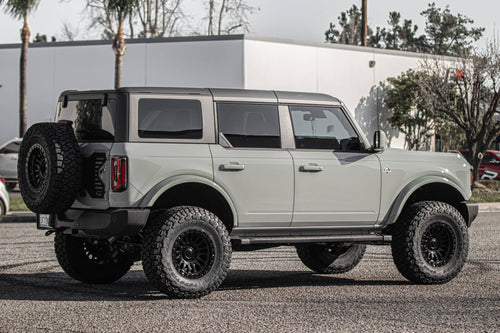 Side profile of a gray four-door Ford Bronco
