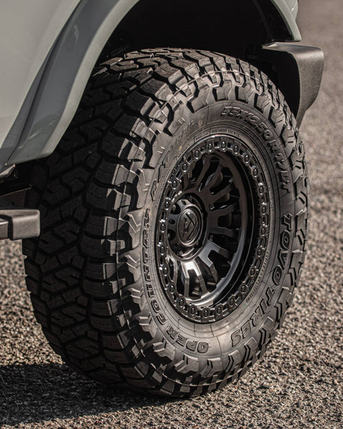 Toyo Tires Open Country R/T tire on a black wheel on a gray Ford Bronco