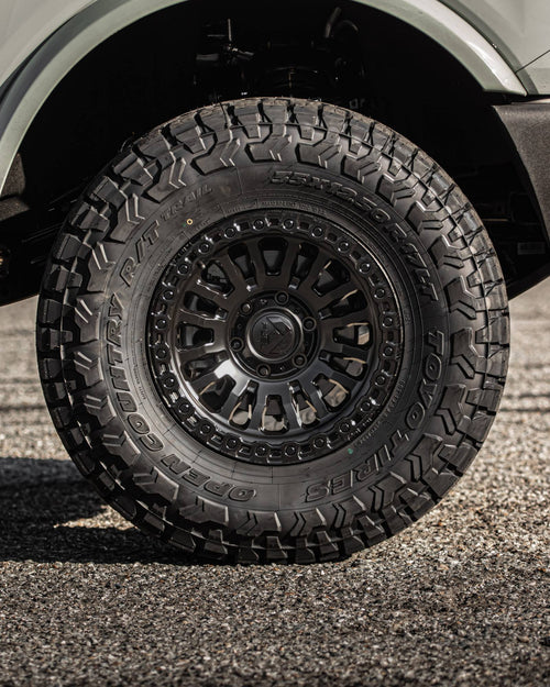 Front wheel and tire on a gray Ford Bronco