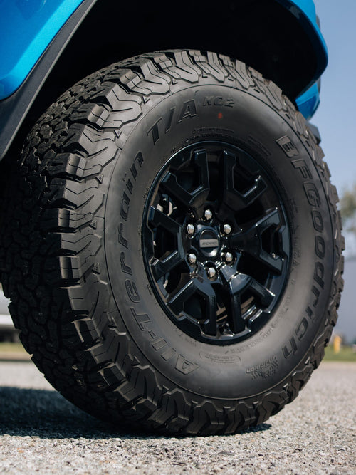 BFGoodrich All-Terrain T/A KO2 tire on a black wheel on a blue Ford Bronco Raptor