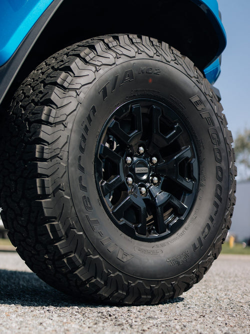 Tread and sidewall of an all-terrain tire on a black wheel, Ford Bronco Raptor