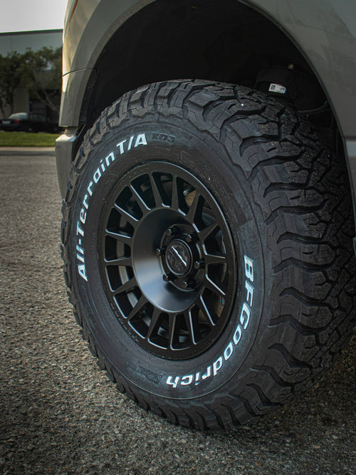BFGoodrich All-Terrain T/A tire on a black wheel on a gray Ford F-150 Lightning