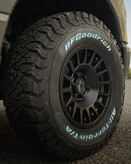 Black wheel with white-lettered BFGoodrich tire on a gray Ford F-150 Lightning