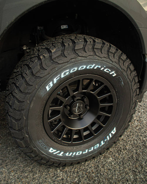 Sidewall and tread of a BFGoodrich all-terrain tire on a black wheel, Ford F-150 Lightning
