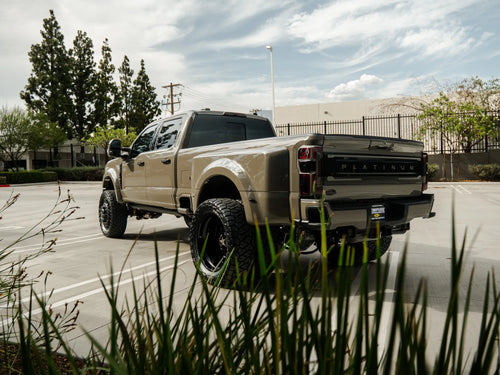 Rear three-quarter view of the lifted Ford F-450 Platinum dually built by Empire Motorsports & LINE-X
