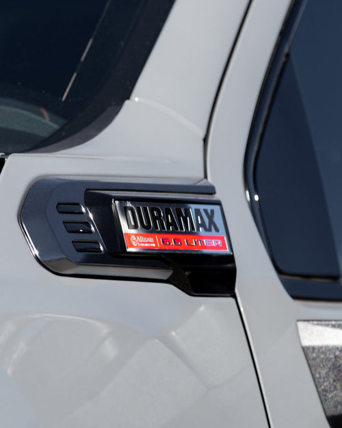 Fender badge on a silver GMC Sierra HD AT4