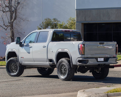 Side profile of a silver GMC Sierra HD AT4 crew cab