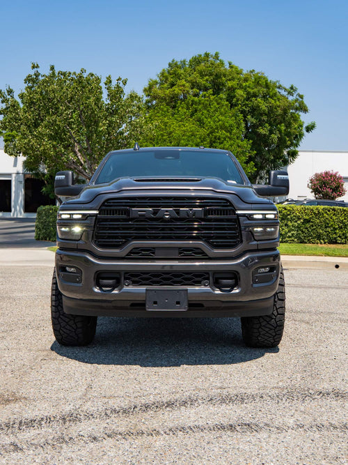 Front view of a lifted gray Ram HD with black wheels