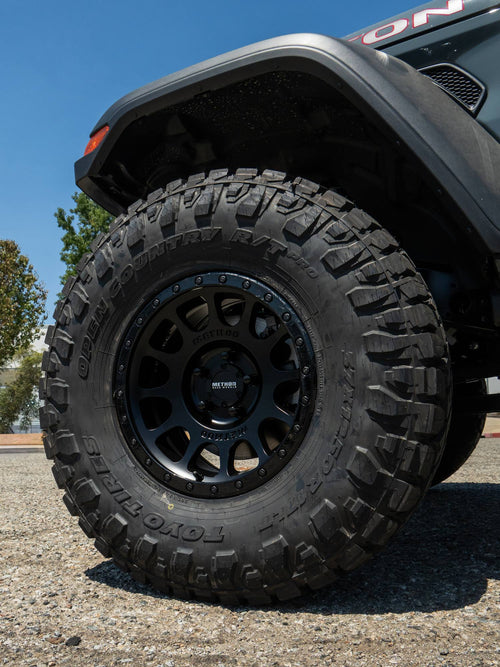 Close-up of a black Method wheel with a Toyo Open Country R/T Pro tire on a Jeep Gladiator