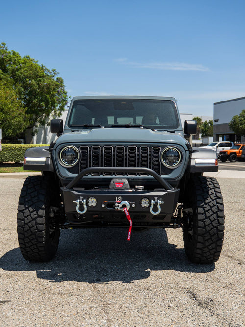 Front view of a gray Jeep Gladiator Rubicon with a Warn winch bumper