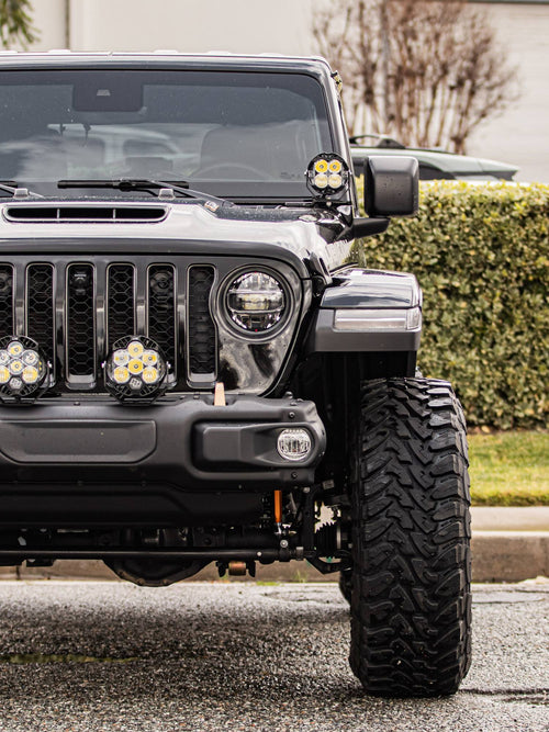 Front bumper, grille and auxiliary lights on a black Jeep Wrangler Rubicon