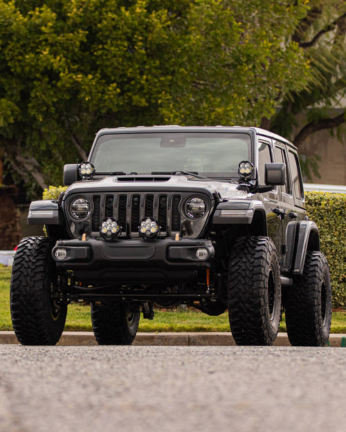 Low front view of a lifted black Jeep Wrangler Rubicon