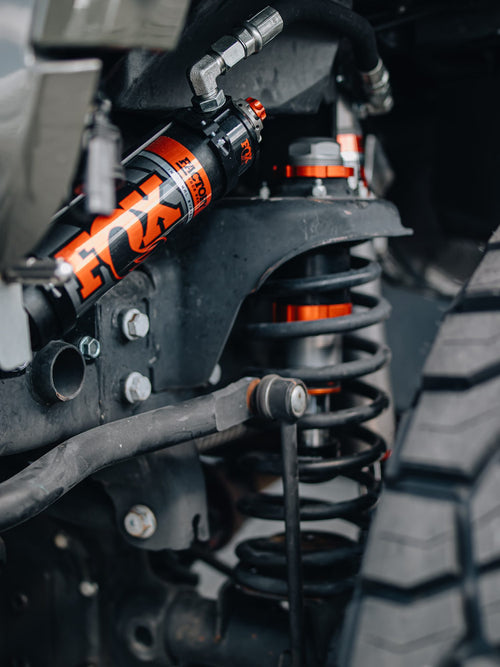 Coil spring and shock in the wheel well of a lifted Jeep Wrangler Rubicon