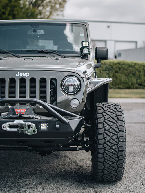 Front grille, winch and bumper on a gray Jeep Wrangler Rubicon