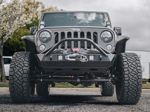 Low front view of a gray Jeep Wrangler Rubicon with a winch bumper