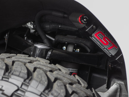 Rear shock mounted above an off-road tire on a Jeep Wrangler Rubicon