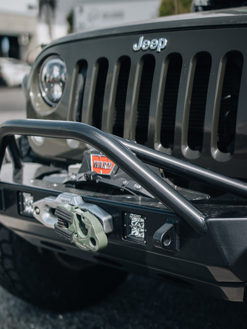 Front winch bumper and seven-slot grille on a gray Jeep Wrangler Rubicon