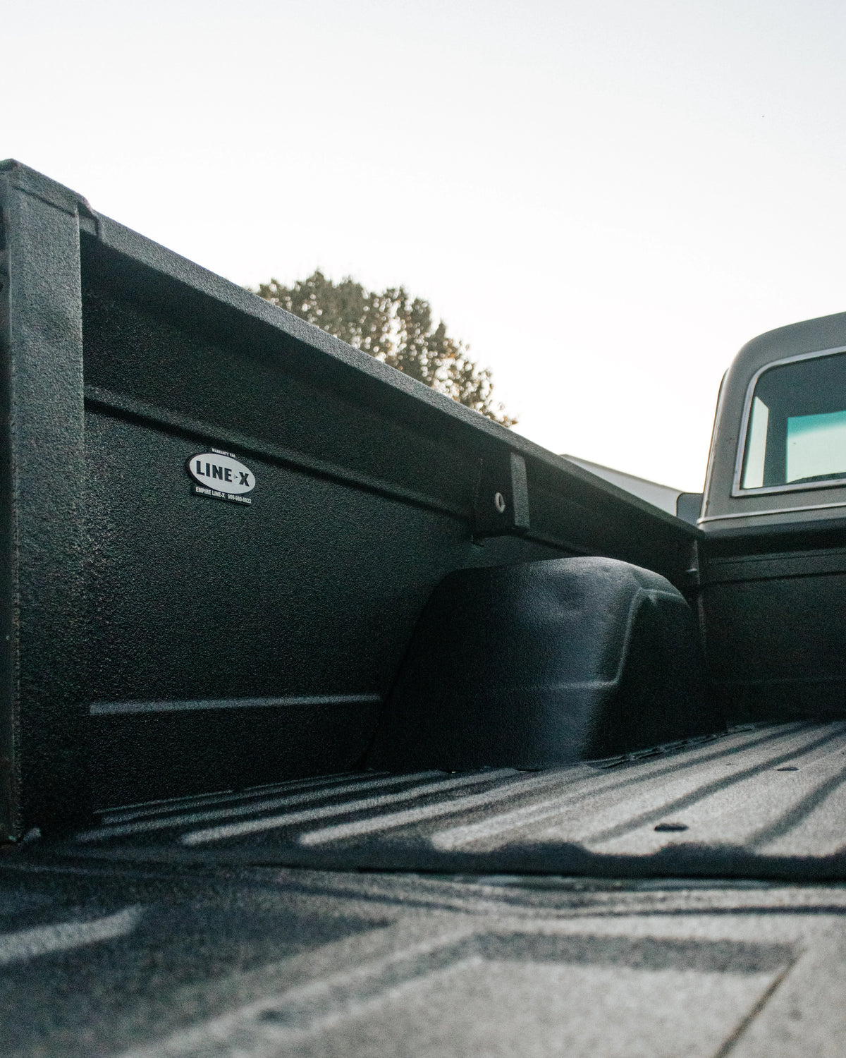 Pickup truck bed restored with LINE-X Renew for a refreshed black textured finish.