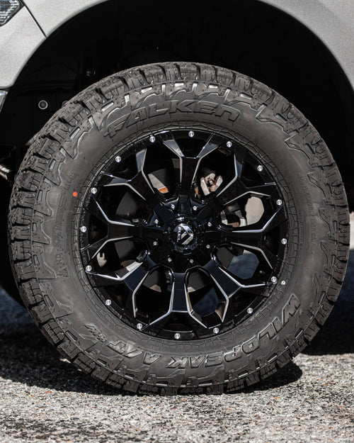 Falken Wildpeak A/T tire on a black-and-machined Fuel wheel on a silver RAM 1500