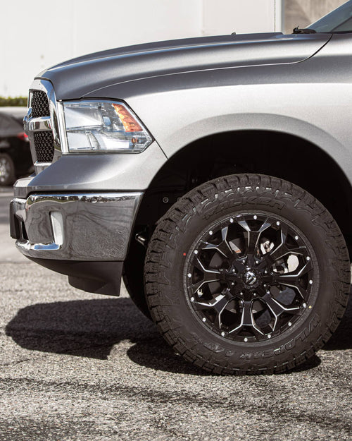 Front fender and black-and-machined wheel on a silver RAM 1500