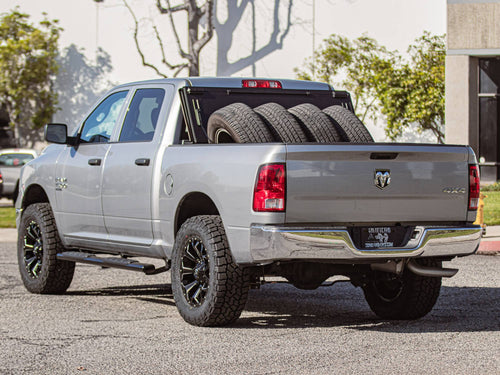 Rear three-quarter view of a silver RAM 1500 with an open bed