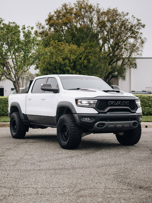 Front view of a white RAM 1500 TRX with black Fuel wheels and Toyo Open Country tires