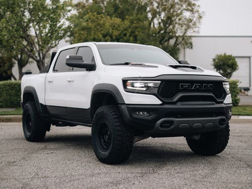 Front three-quarter view of a white RAM 1500 TRX with Fuel wheels and Toyo tires