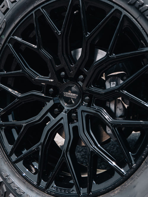 Close-up of a black Vossen hybrid forged wheel