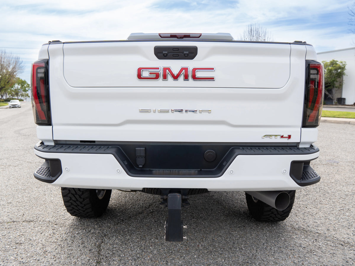 Rear view of a white GMC Sierra AT4 equipped with a heavy-duty trailer hitch receiver.